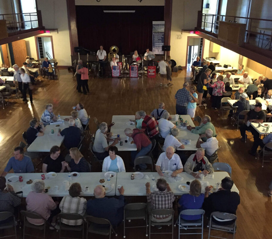 Inside Cashton Community Hall. People sitting at table.