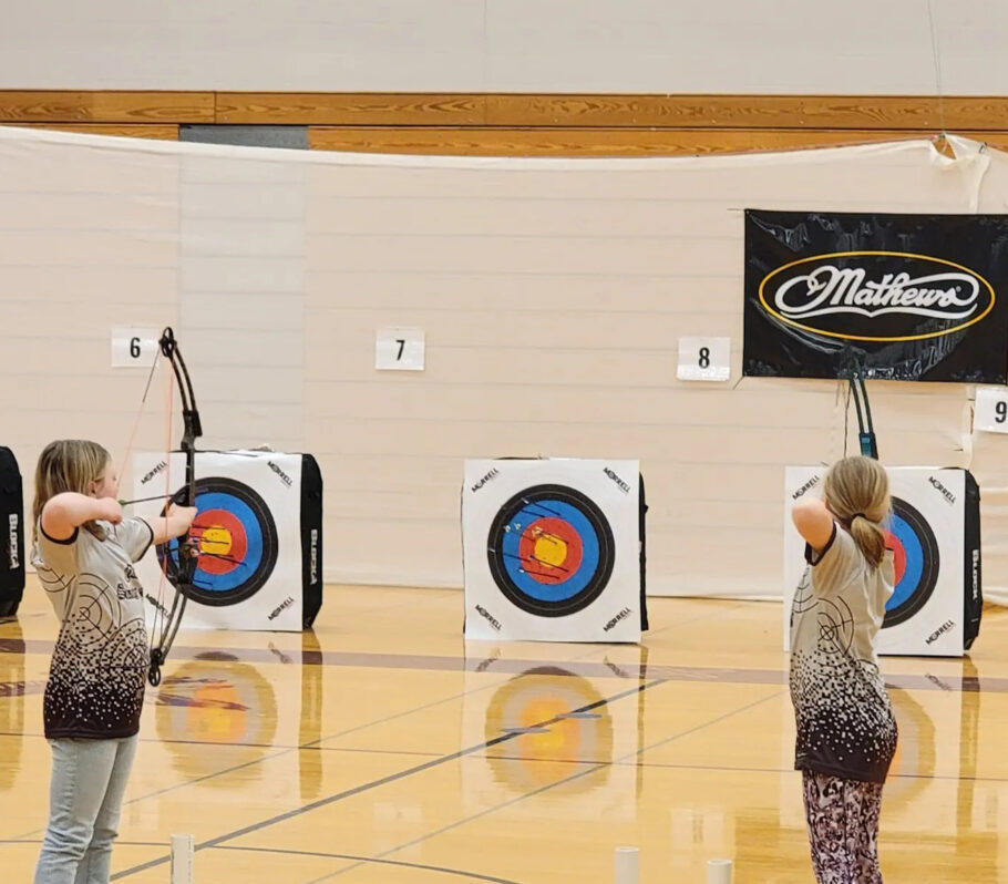 Cashton Archery. Two team members holding bows and aiming at targets.