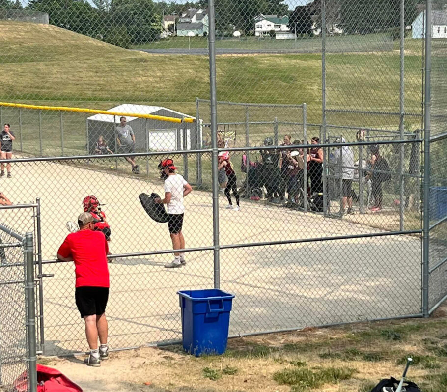 Summer Rec Softball. Picture of coach watching game.