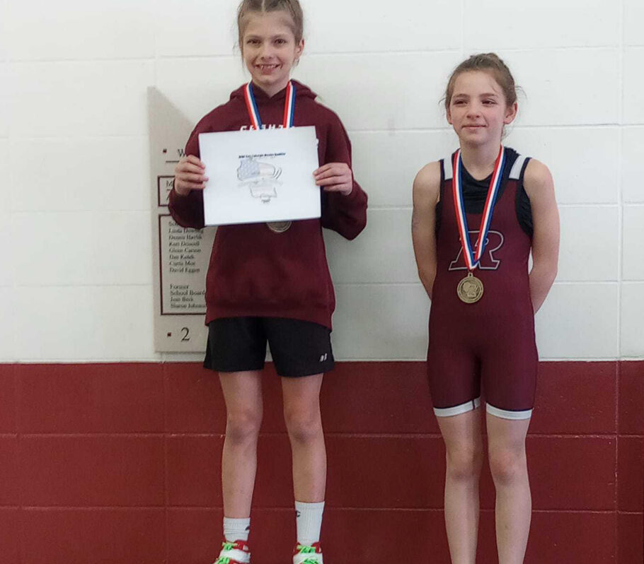 Youth girls wrestling. Image showing two girls on posing on podium with medals.