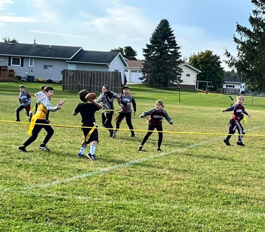 Cashton Youth Flag Football. Young kids in field playing.