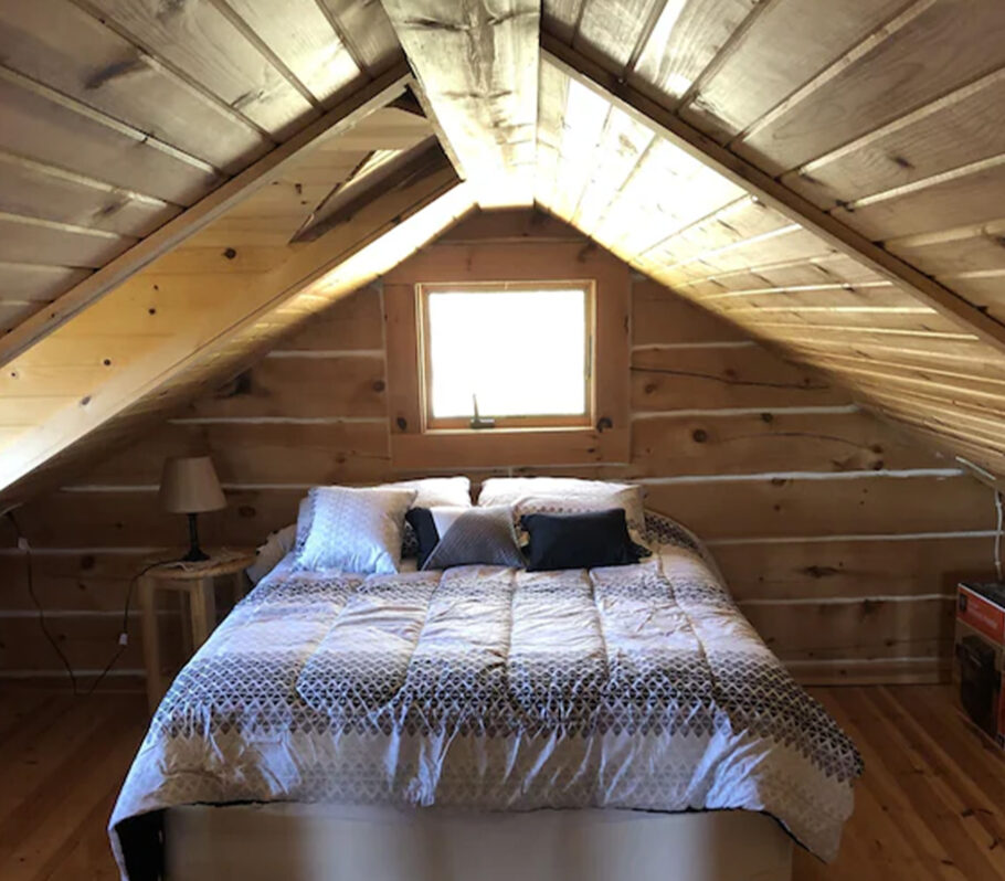 Airbnb lodging in Vernon County. Picture showing interior of wood cabin bedroom.