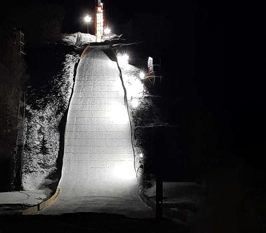 Snowflake Ski Jump. Dramatic black and white image of hill straight on towards the bottom of the run.
