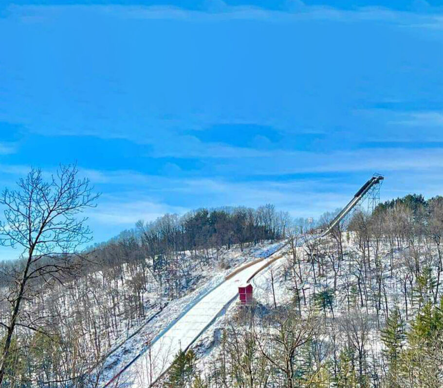 Snowflake Ski Jump. Image of run with blue sky.